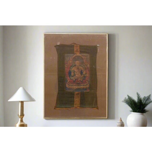 This antique Tibetan thangka, painted with meticulous detail and imbued with spiritual significance, invites contemplation...