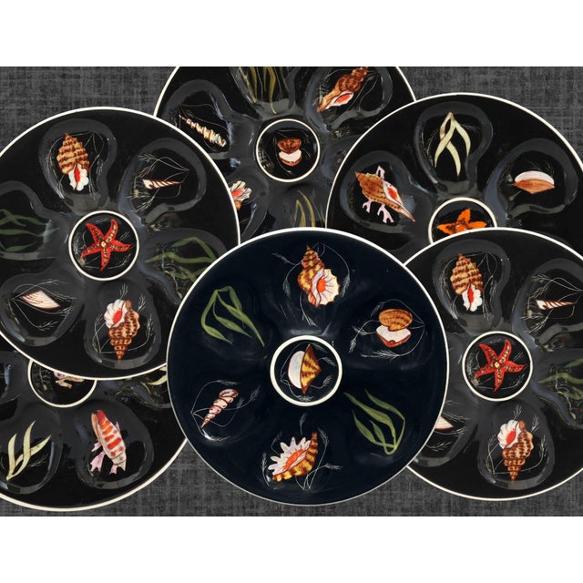 A striking set of six Henriot Quimper oyster plates, each hand-painted by celebrated Quimper artist Guy Trévoux. Finished...