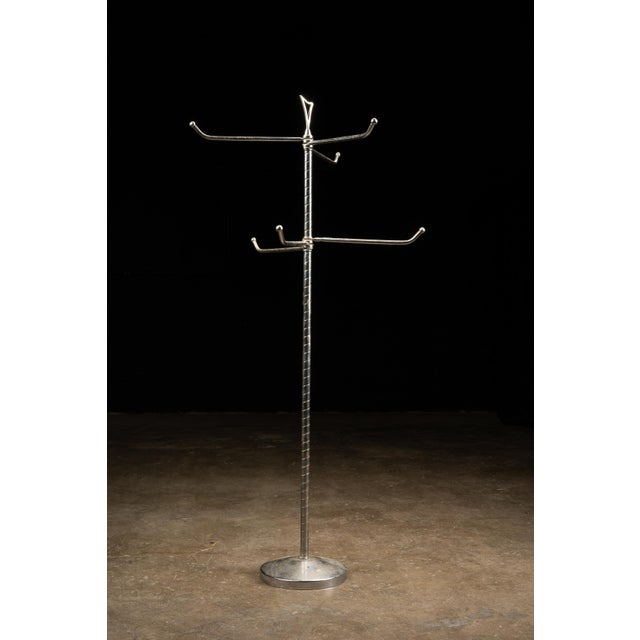 This vintage store display features nickel plating and can be adjusted for the hanging of a number of goods. It is...