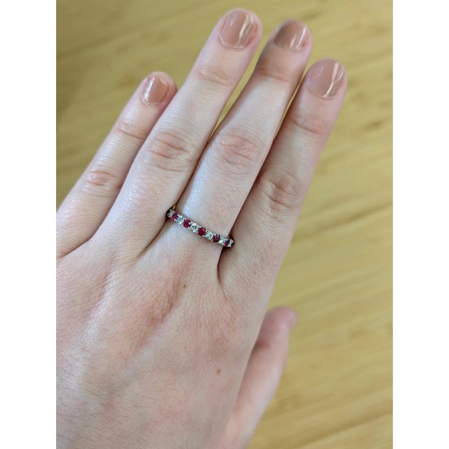 Round rubies and diamonds dance across a solid 14K white gold band, bringing timeless sparkle with a bold pop of red....