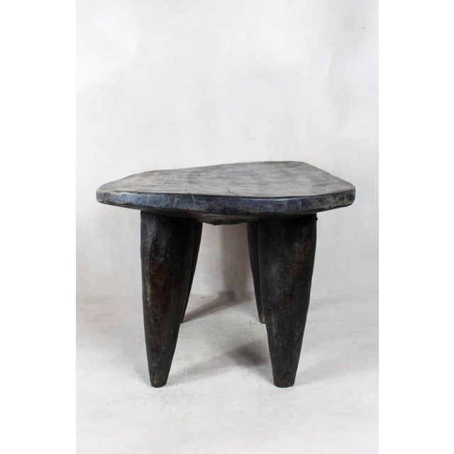 Elevate your living space with the authentic charm of the Senufo Stool, a masterpiece of African craftsmanship. Hand-...