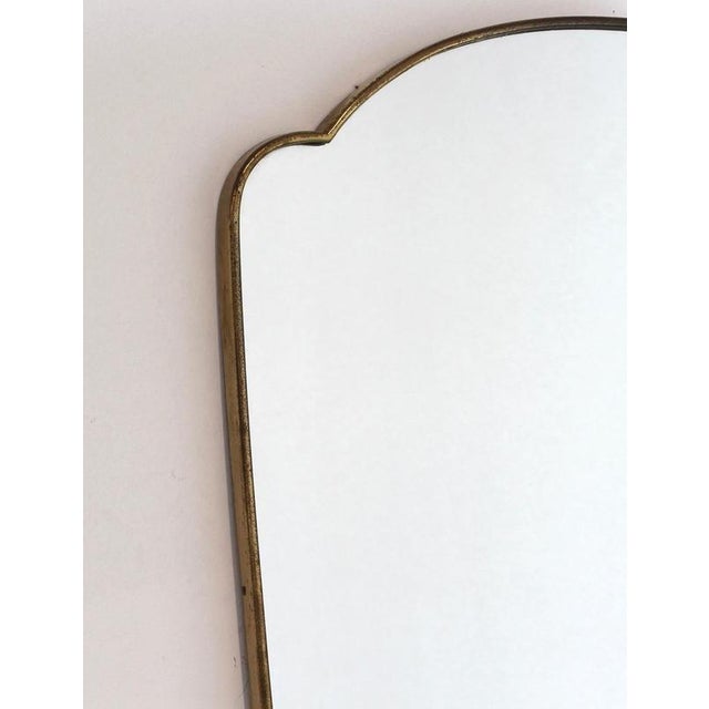 Mid-Century Italian wall mirror with brass frame (circa 1960s). This mirror is simply elegant and characterful in a...