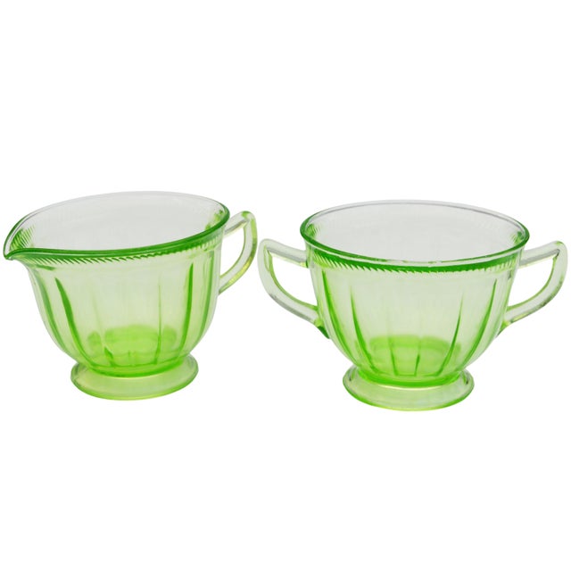 Stunning set of two antique handblown glass sugar and matching creamer bowl, constructed in playful sleek silhouettes with...