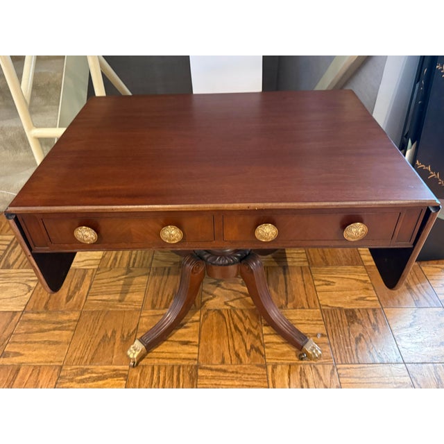 Handsome mahogany drop‑leaf sofa table that expands to a generous surface, perfect for behind a sofa, in a hallway, or as...