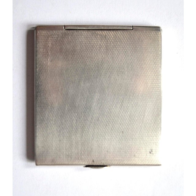 A very attractive silver matchbook (also suitable for small business cards). The front and back are decorated with a...