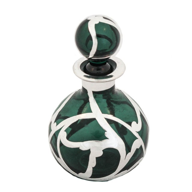 Being offered is a sterling silver and crystal perfume bottle from the Art Nouveau period. It has a deep-green glass with...