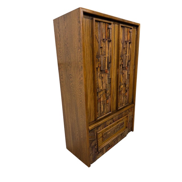Stunning Mid-Century Modern Lane Pueblo Brutalist Oak Armoire, dating back to the 1970s! This highly collectible piece...