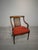 Biedermeier-style armchair from the 1950s with a raffia backrest and a red upholstered seat. The wooden frame features...