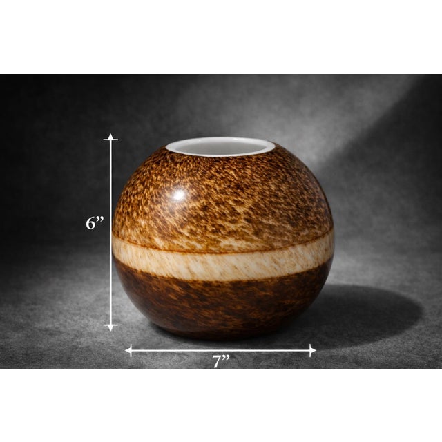 Beautiful studio pottery orb vase featuring a rich tortoiseshell-style glaze with a contrasting cream band. The rounded...