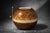 Beautiful studio pottery orb vase featuring a rich tortoiseshell-style glaze with a contrasting cream band. The rounded...