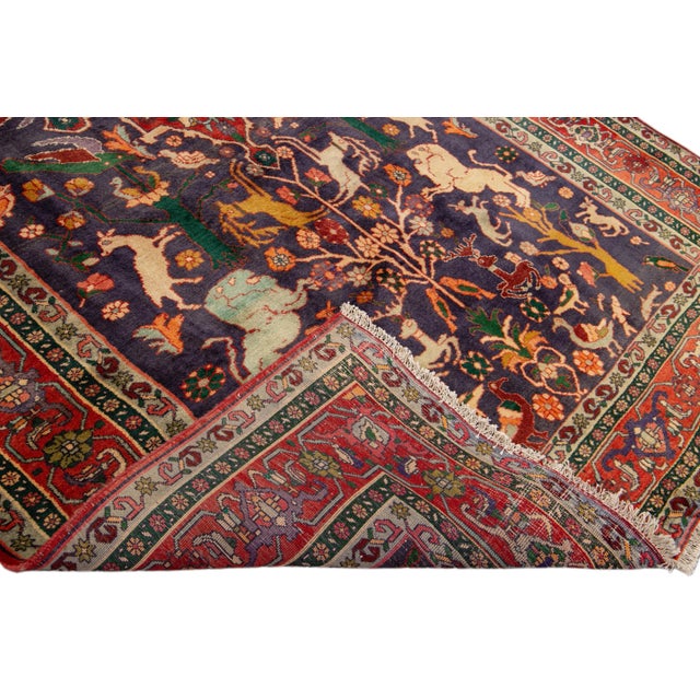 Beautiful vintage Persian Shiraz hand-knotted wool rug with a blue field. This piece has designed a multi-color frame and...