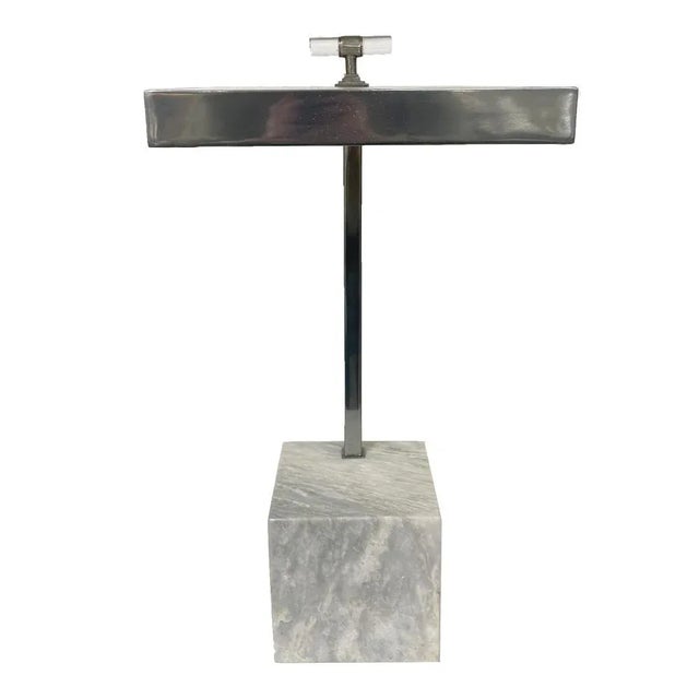 By Century Furniture Company, this stylish contemporary drinks table features a solid marble block base in which a brushed...
