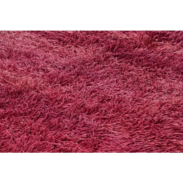 Hand-knotted in wool and originating from Morocco circa 1950-1960, this 7x8 vintage rug is a rare and among the most...