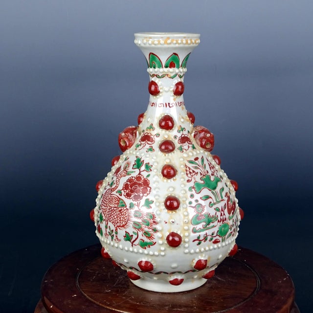 W-21cm,H-34.6cm The Blue and White Famille Verte Porcelain Yuhuchun Vase features intricate paintings of flowers and...