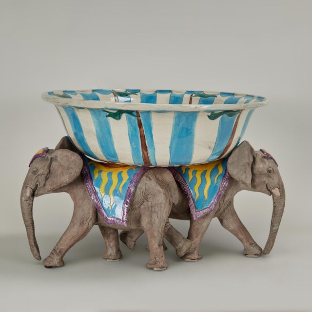 Whimsical hand crafted ceramic bowl on stand. The bowl is hand decorated with stylized circus performers around a swirling...