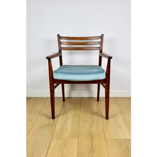 Vintage office armchair in sea turquoise colour. A vintage office chair from the 1970s. The wooden frame and seat have...