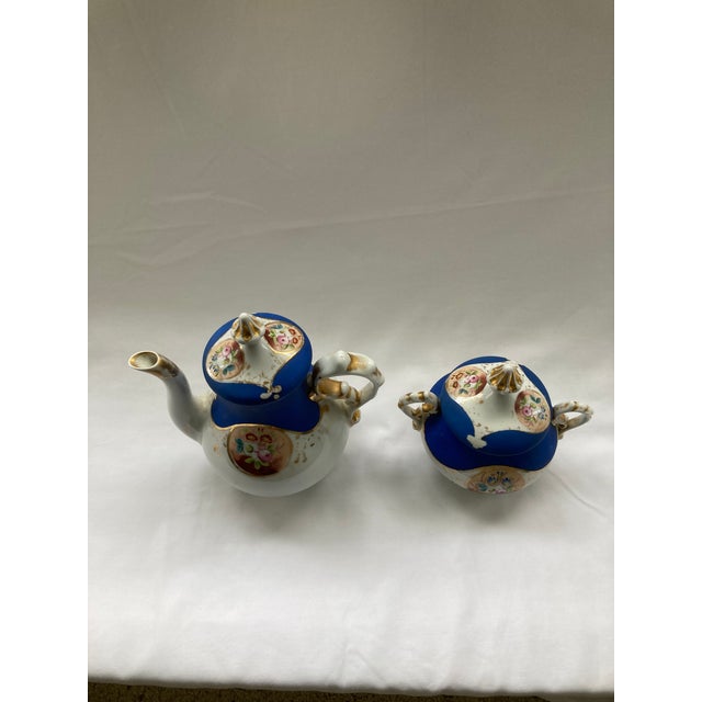 This is a Vintage Porcelain Tea Set with delicate floral decoration reflective of European porcelain makers in the...