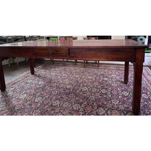 Beautiful age and patina on this antique farmhouse refectory table with breadboard ends over a deep apron at and 3 sizable...