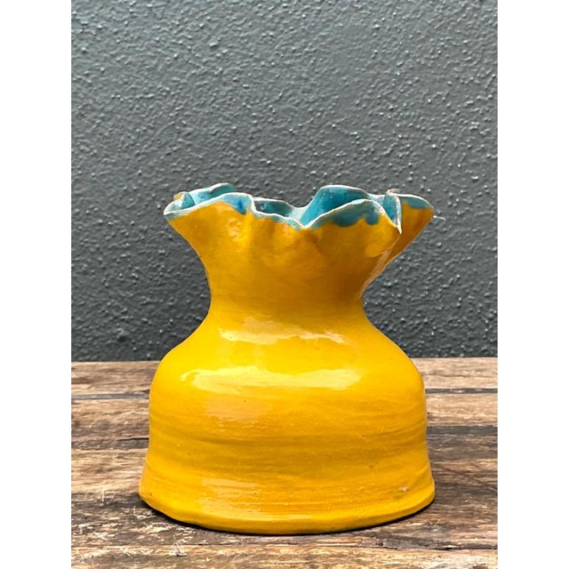 This studio pottery vase makes an immediate visual impact through its bold color pairing and expressive silhouette. The...