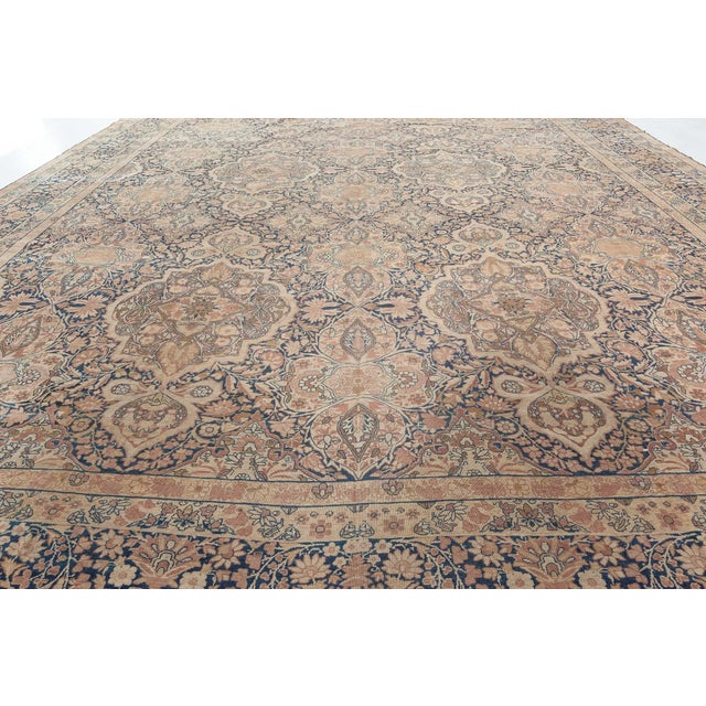 An exceptional example from the DLB collection of late 19th century antique Kerman Persian rugs, the midnight blue field...