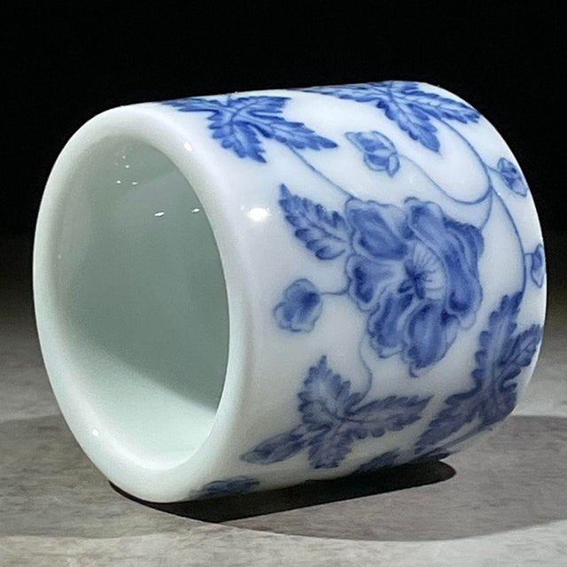 A charming Chinese blue and white porcelain thumb ring (ban zhi). Originally used for archery to protect the thumb, these...