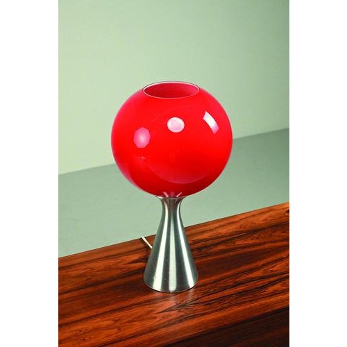Large model Erco Space Age table lamp from the 70’s and made of aluminum and red glass shade. Refined design from a well...