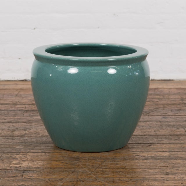 A Midcentury teal glazed ceramic garden planter with circular mouth and tapering lines. Hailing from the golden age of...