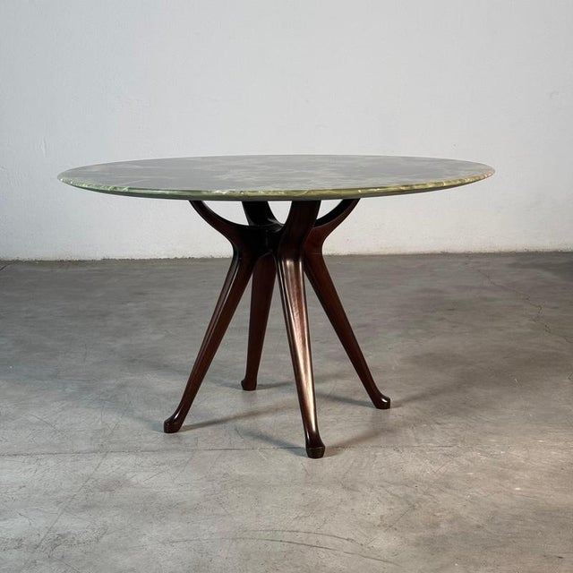 This exceptional dining table is a rare and highly refined example of Italian post-war design, custom made in the 1950s...