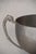A two-handled silver cup on a turned wooden base engraved with a winners' inscription, carrying the unpolished patina of a...