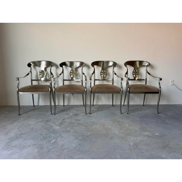 Elegant and timeless, this Vintage Neoclassical-Style Dining Set features a stunning mix of brushed steel and brass...