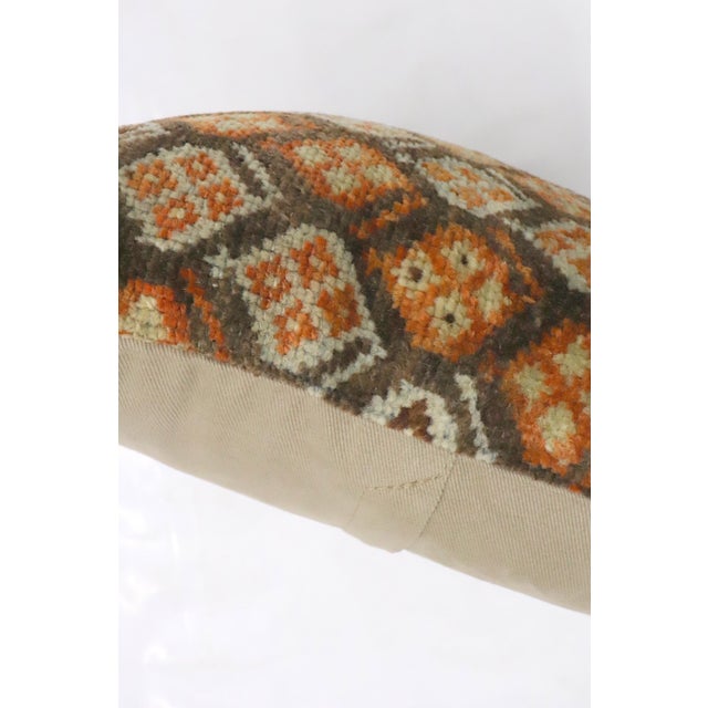 A bolster size rug pillow from an antique persian kurd rug 11'' x 20''