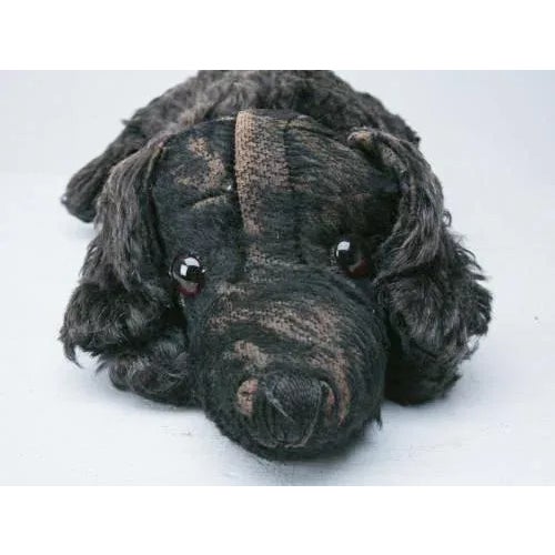 cuddly dog will keep your PJs warm in its belly until bedtime. He has a tag on his underside reading, "Merrythought...