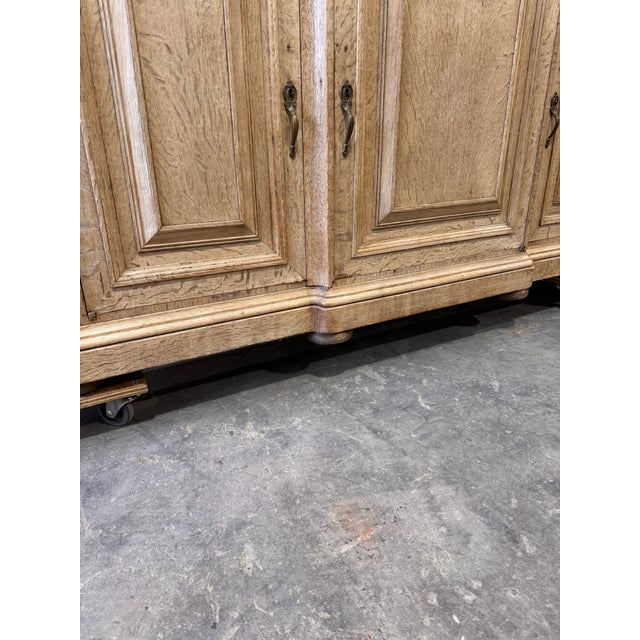 This is a Early 20th century bleached oak server is perfect for your room that needs a little light. Three doors that open...