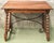 About 19th Spanish farm table with iron stretchers, hand carved top and drawer. An unusual form with nice shiny patina....