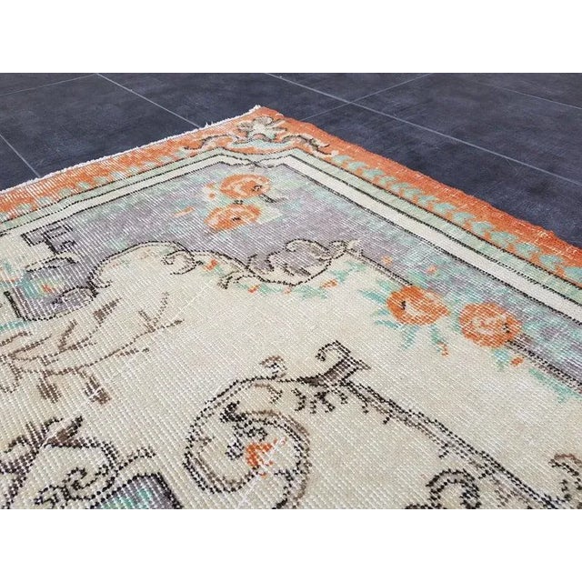 This is a vintage Turkish Oushak rug from the 1960s. The piece was hand-knotted.