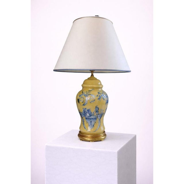 Elegant Italian table lamp from the 1950s, featuring a richly glazed yellow porcelain body decorated in cobalt-blue with...