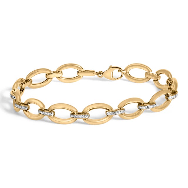 Command attention with a modern classic: a bold open-oval link bracelet bathed in luminous yellow gold, its mirror-...