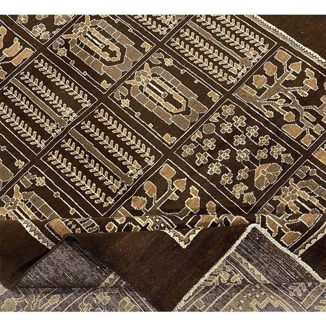 Old Persian Shiraz area rug featuring an all-over tile design on a chocolate brown background. Hand-woven from a luxurious...