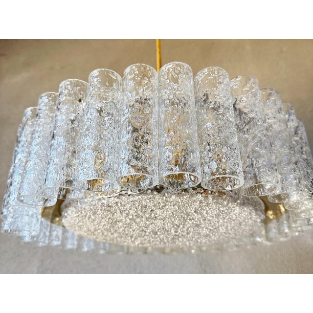 Large round midcentury ceiling lamp by Doria Leuchten, Germany. Around 32 thick hand-blown round glass tubes with relief...