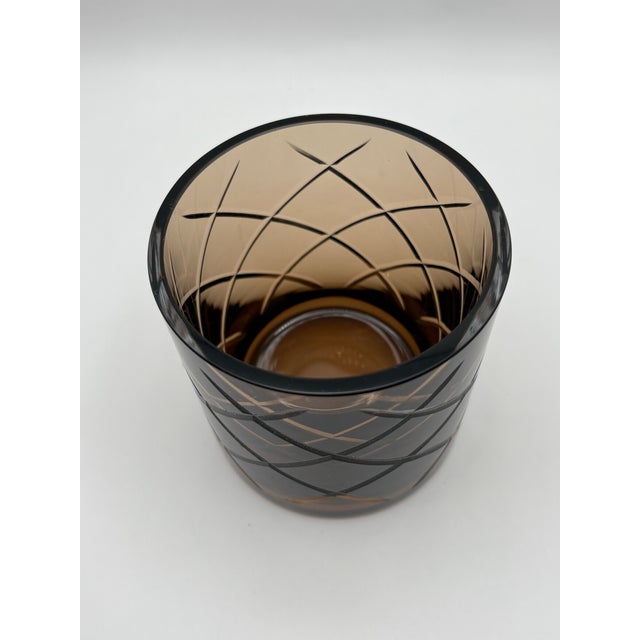 Stylish and warn this 4” cut glass candle holder/vase features elegantly cut diagonal lines. The walnut color glass is...