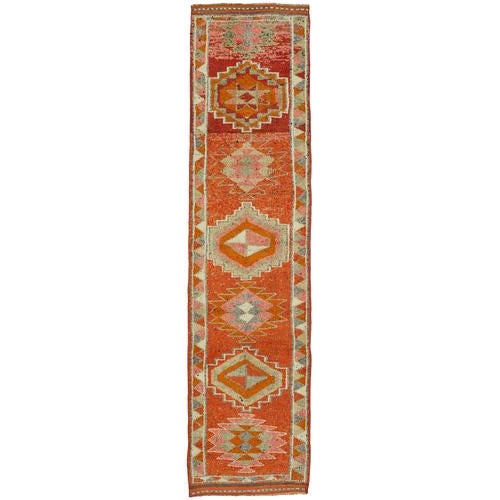 This exquisite runner rug is a rare example of tribal craftsmanship, hand-knotted by the women of the Herki tribe during...