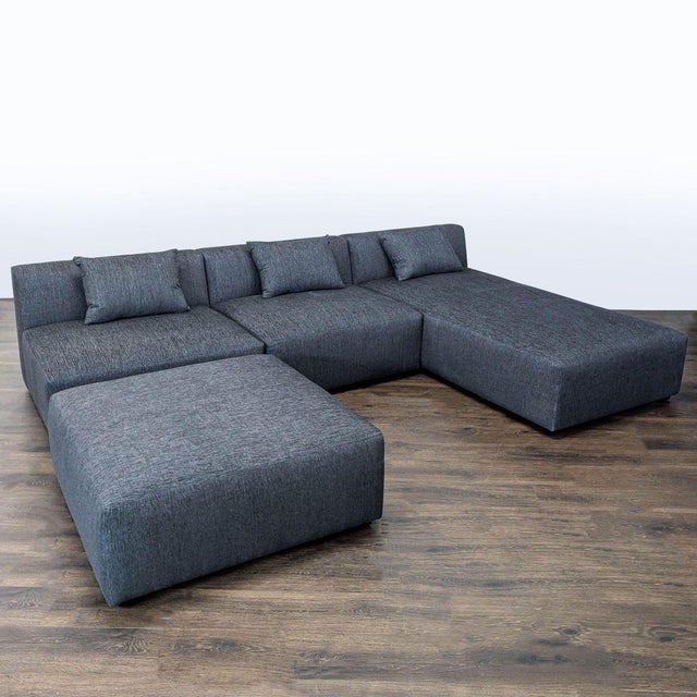 This Maiden Home sectional offers a stylish and spacious seating solution for any living room. The modern dark gray...