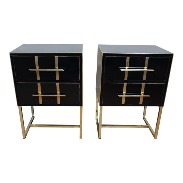 The nightstand, with its black glass surface, exudes a sense of freshness and elegance. Refined brass details extend along...