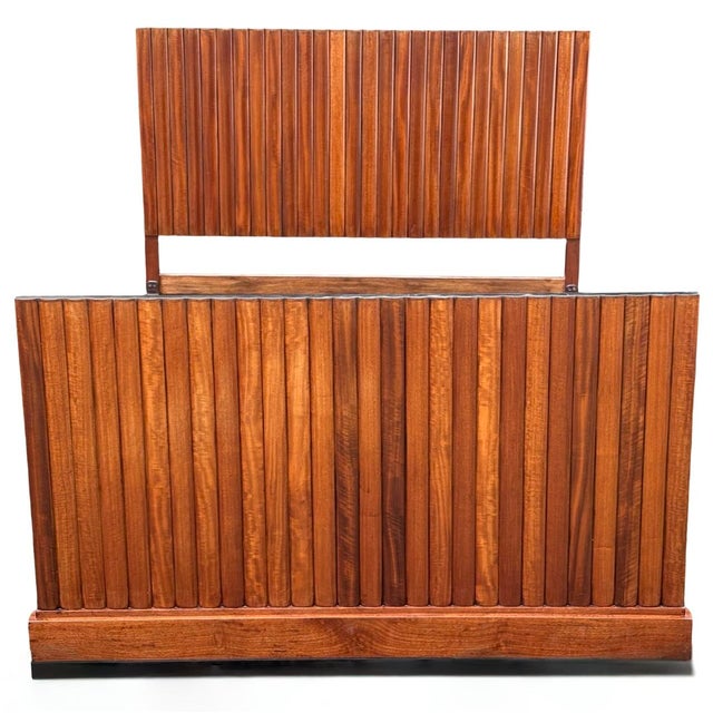 A stunning Queen size Art Deco Bed in figured walnut. The headboard and footboard are both fluted and ebonised to their...