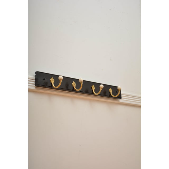 K0311 brass and ceramic set of four very decorative victorian coat hooks now on solid mahogany ebonised backing. cleaned,...