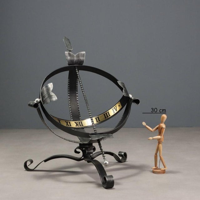 Outdoor sundial in wrought iron with brass plate with Roman numeral hours. This piece is attributed to the mentioned...