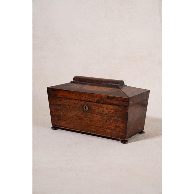 William IV rosewood tea caddy with original interior fittings, bun feet, and a hinged lid. Rich rosewood grain and classic...