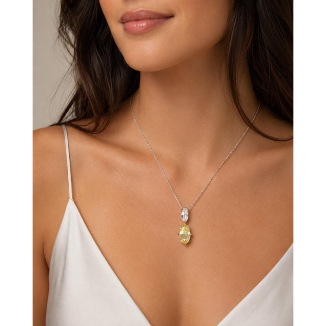Platinum Necklace with GIA certified 2.02 carat oval fancy intense, internally flawless yellow diamond and 0.60 carat F...