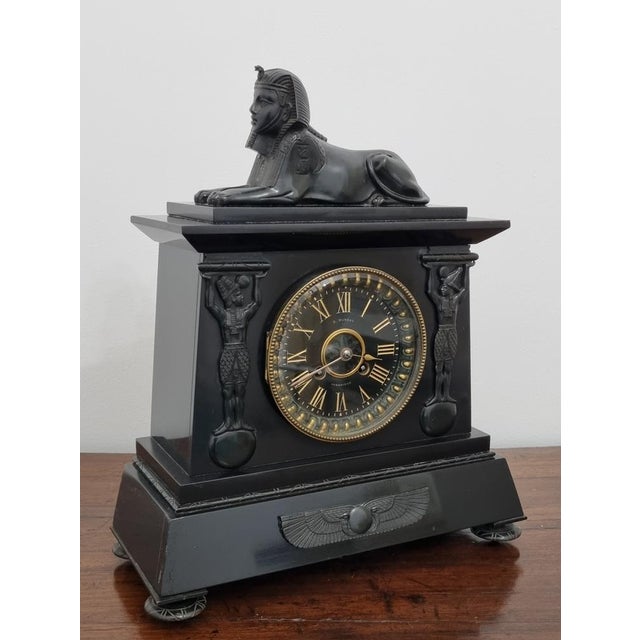 A fine egyptian revival mantel clock retailed by d. Munsey of cambridge, circa 1880s, black marble and slate clock case...