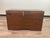 A rectangular wooden campaign trunk or blanket chest with dovetail joinery, brown stain finish, hinged lid opening,...